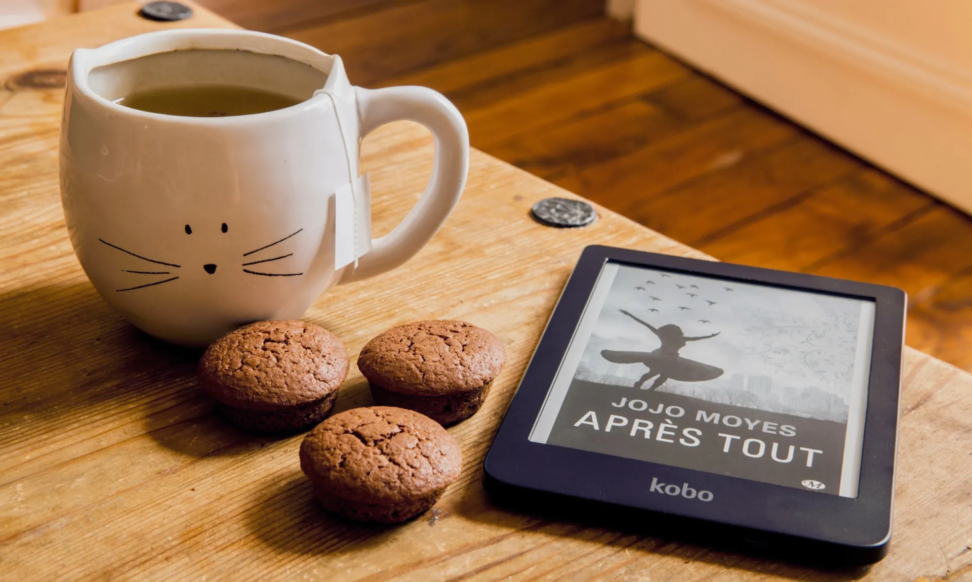 ereader with a cup of tea and cookies