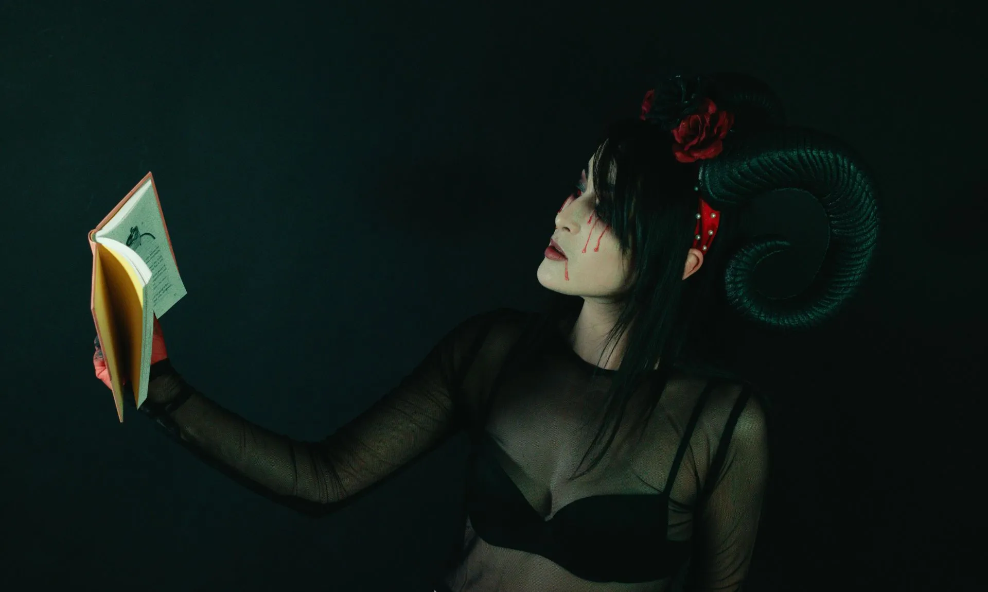 Symbolic representation of injured girl reading a body horror genre book relating to Disseverment
