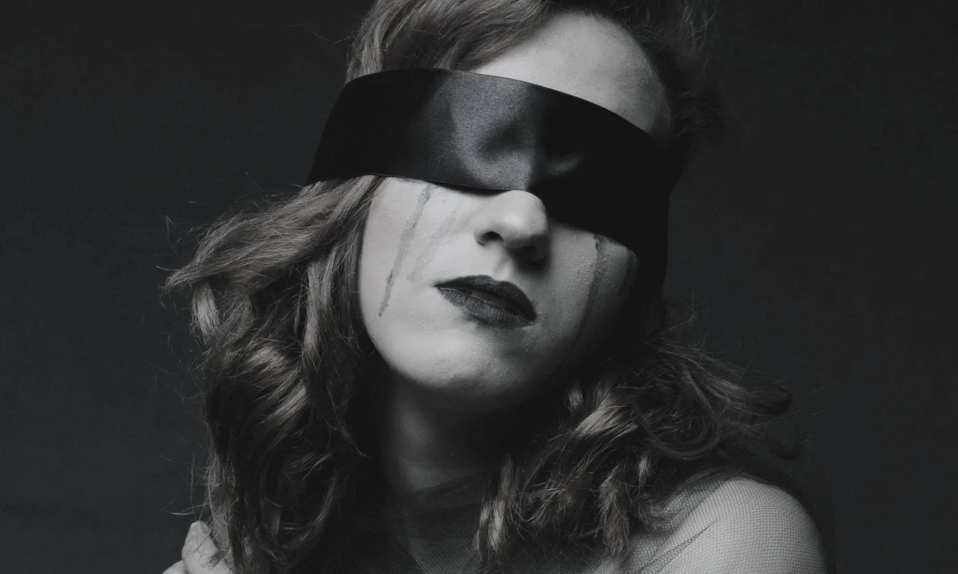 woman blindfolded and depressed