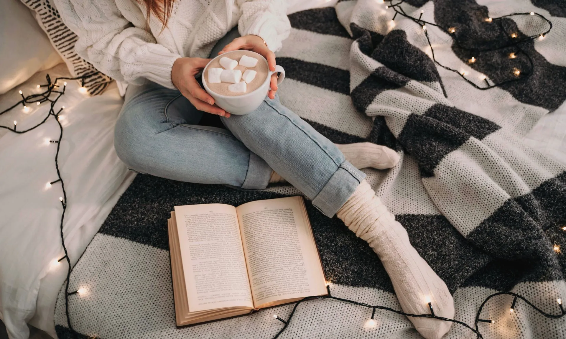 a girl sitting and reading feel-good books with holiday vibe