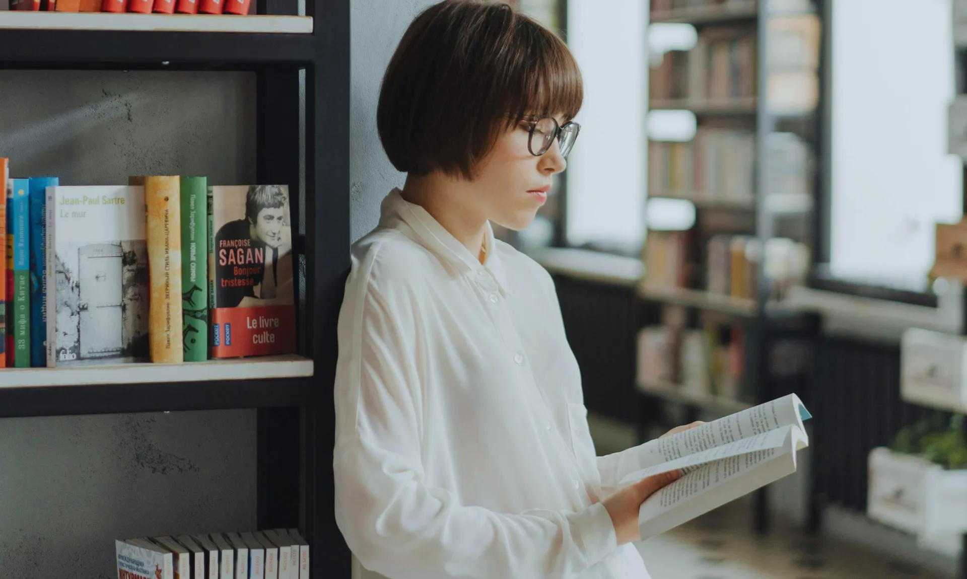 a-girl-reading-in-library a girl reading a book in the library