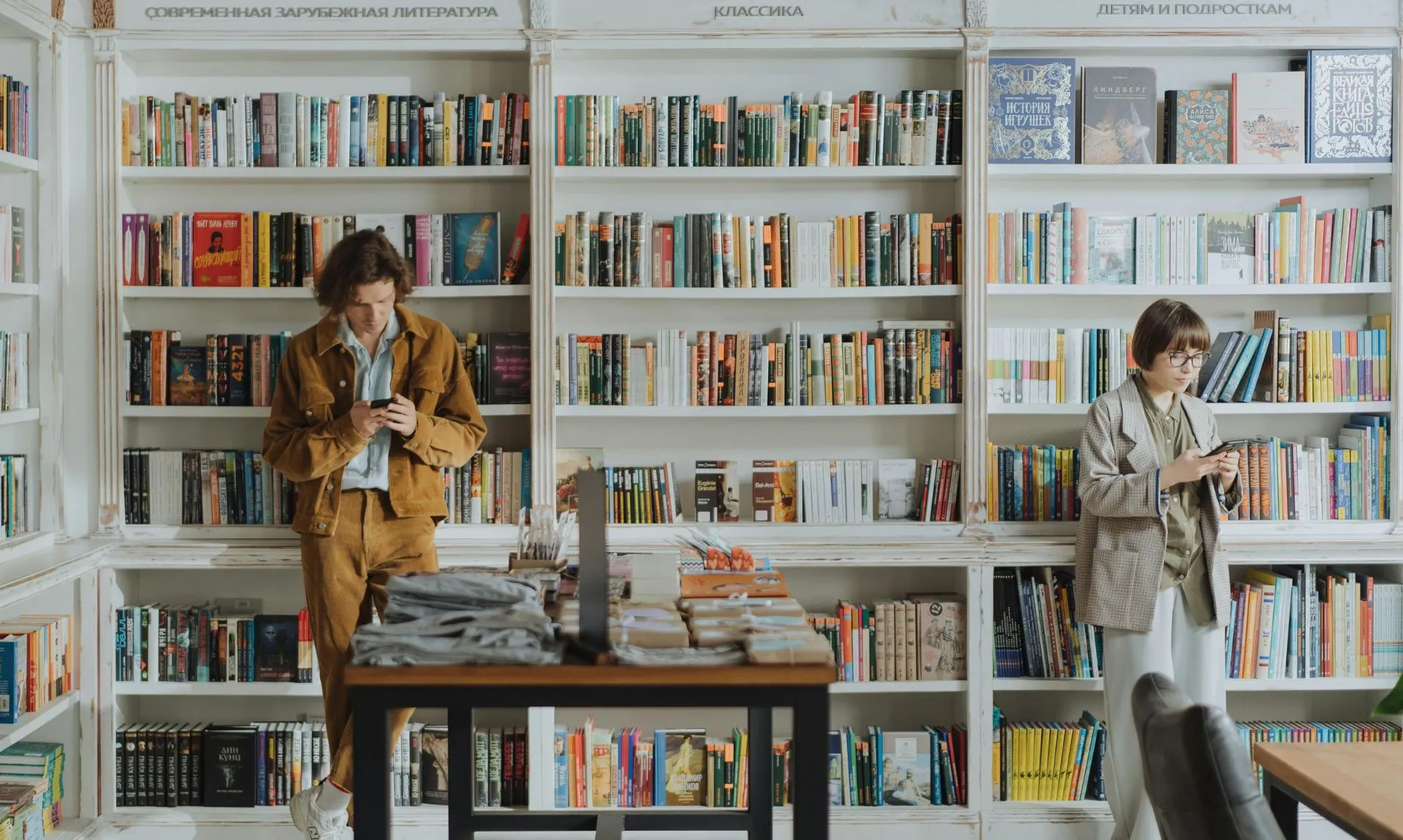 readers-in-library-exploring-contemporary-books a girl and a boy in a library exploring contemporary books