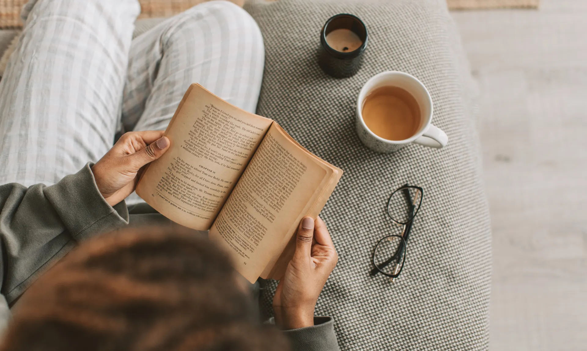 a reader with a book and cup of tea