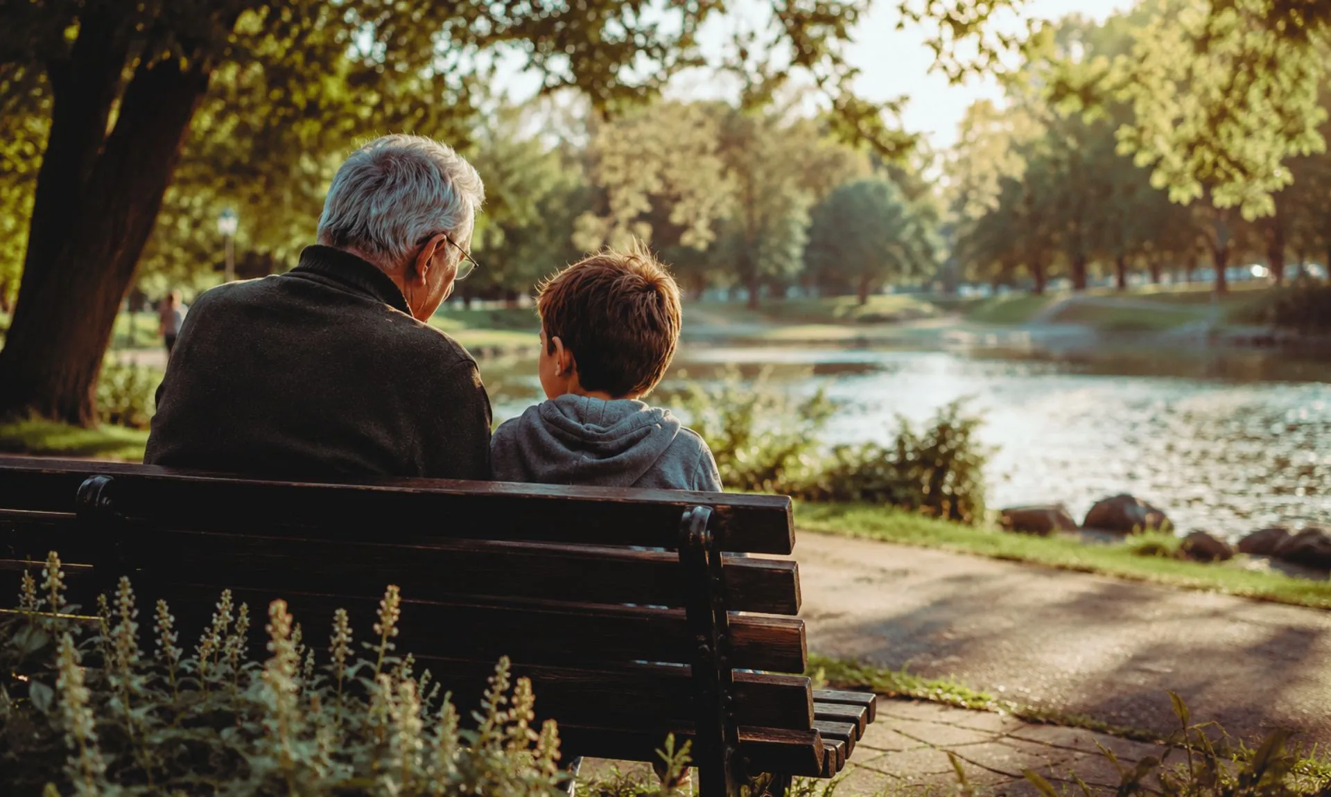 grandfather-and-grandson-sitting-on-a-bench grandfather nd grandson sitting in a park