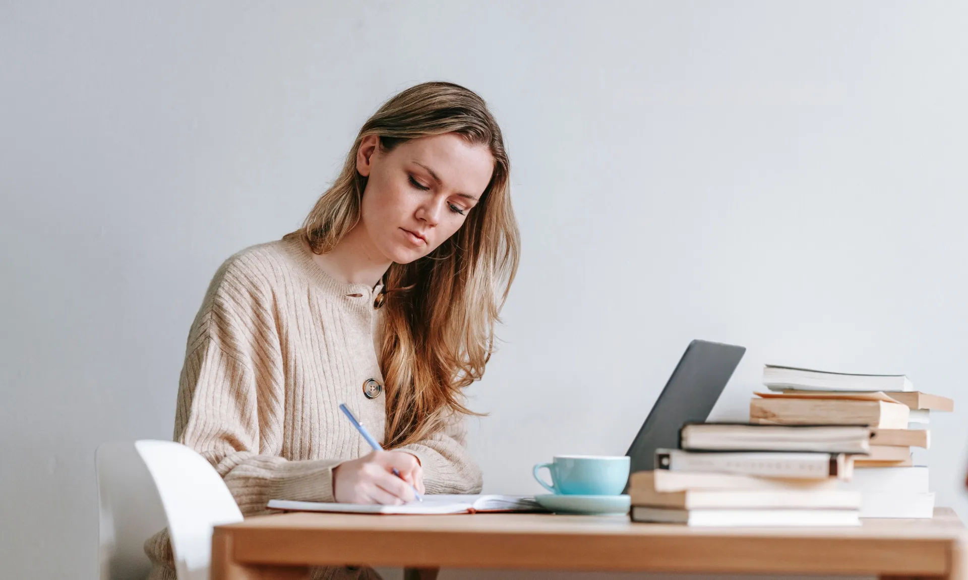a girl writing book reviews to get paid to read books