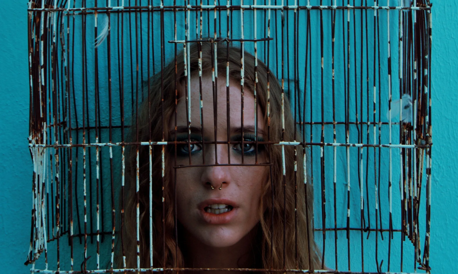 girl-in-cage a girl trapped in a rusty bird cage