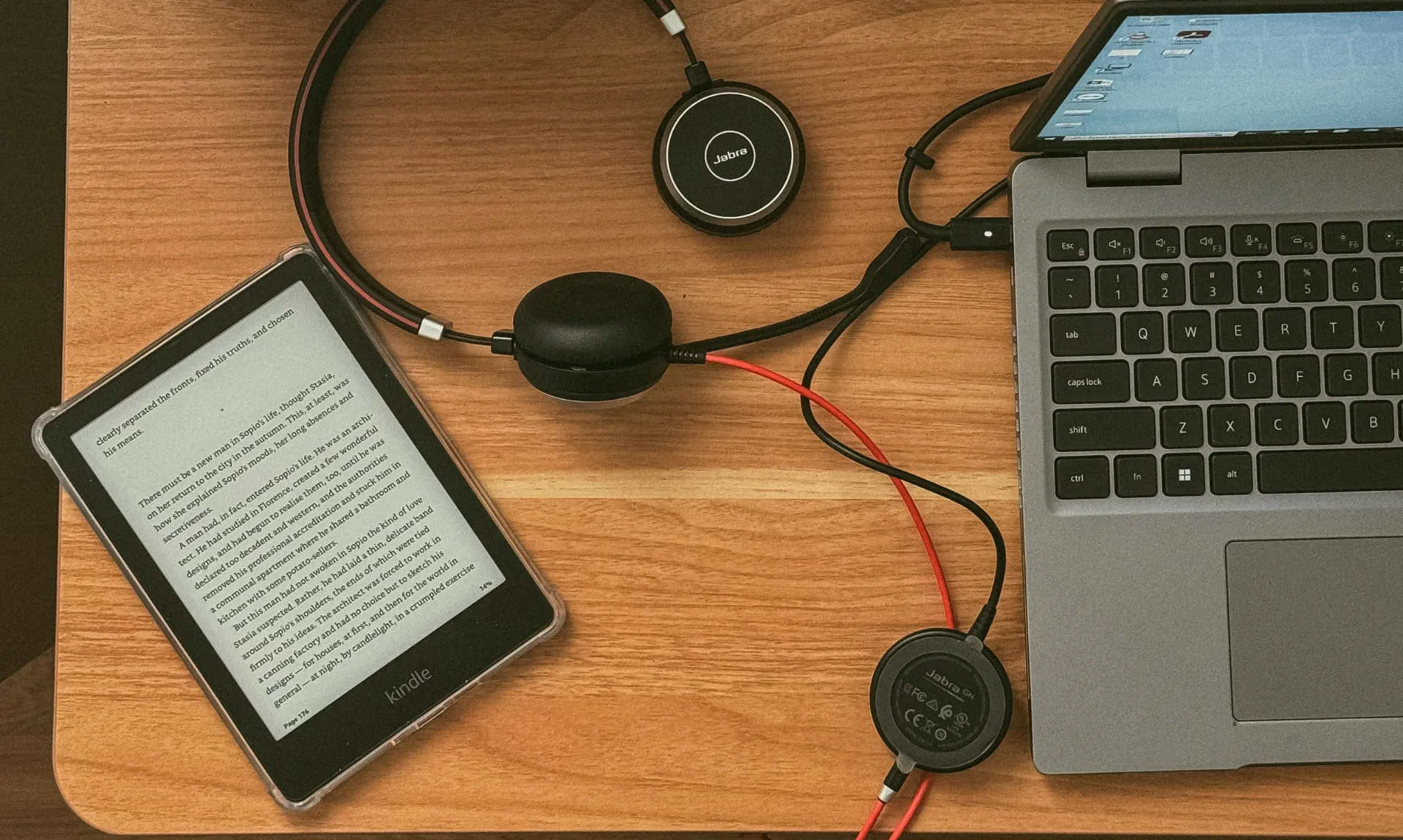 kindle with laptop and headphones representing best speculative fiction books to read on kindle unlimited