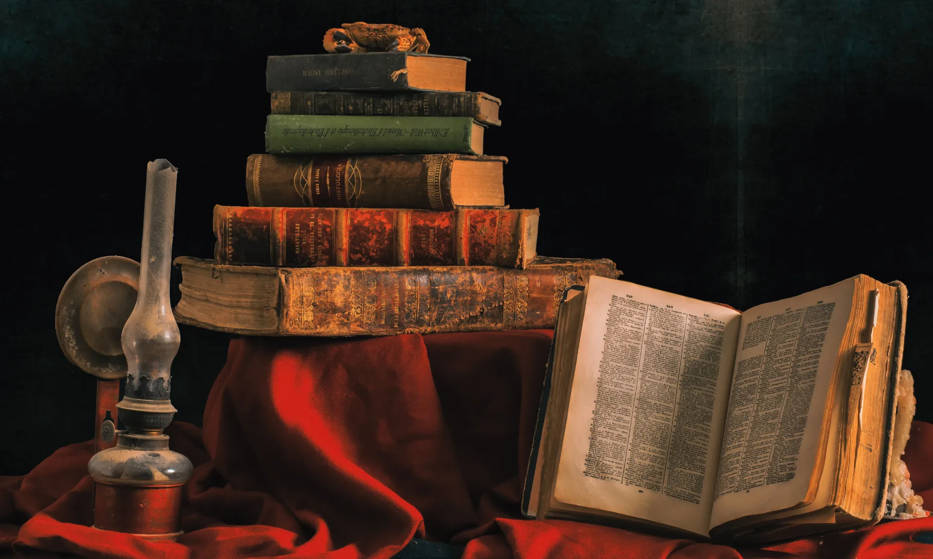a stack of books and a candle holder